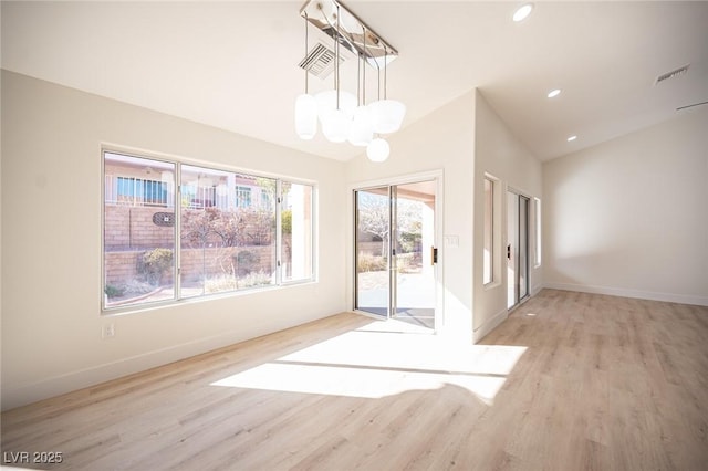 unfurnished dining area featuring baseboards, recessed lighting, a chandelier, light wood finished floors, and vaulted ceiling