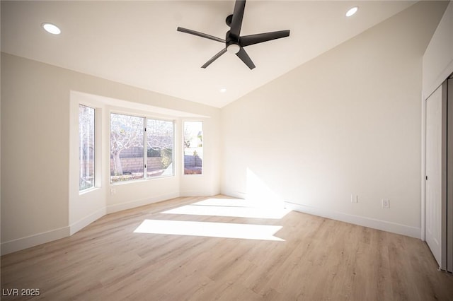 interior space with a ceiling fan, baseboards, lofted ceiling, recessed lighting, and light wood-style flooring
