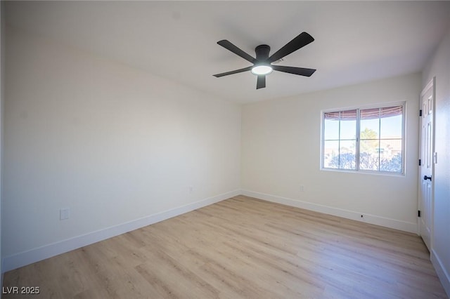 empty room featuring baseboards, light wood finished floors, and ceiling fan