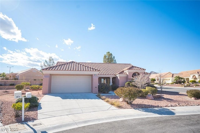 mediterranean / spanish house featuring an attached garage, a tiled roof, concrete driveway, and stucco siding