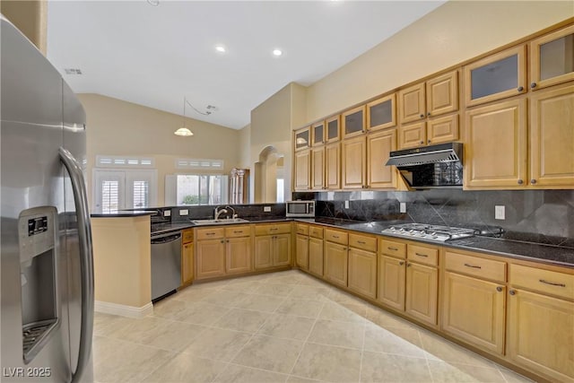kitchen with tasteful backsplash, a sink, light tile patterned floors, a peninsula, and stainless steel appliances