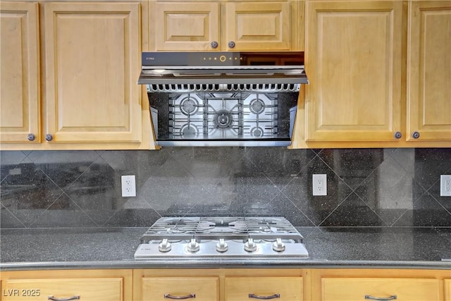kitchen featuring tasteful backsplash, light brown cabinets, dark countertops, and stainless steel gas stovetop