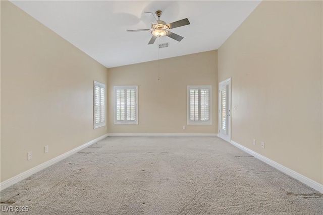 empty room with baseboards, ceiling fan, a healthy amount of sunlight, and light colored carpet
