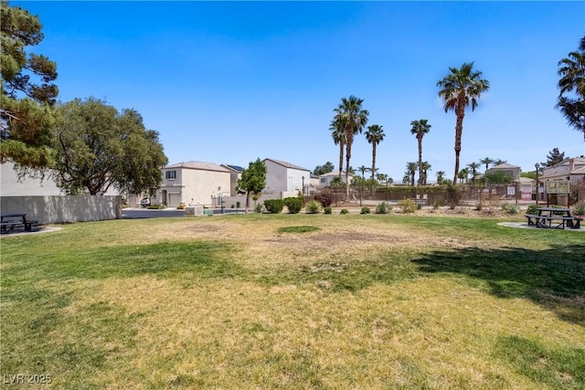 view of yard featuring fence and a residential view