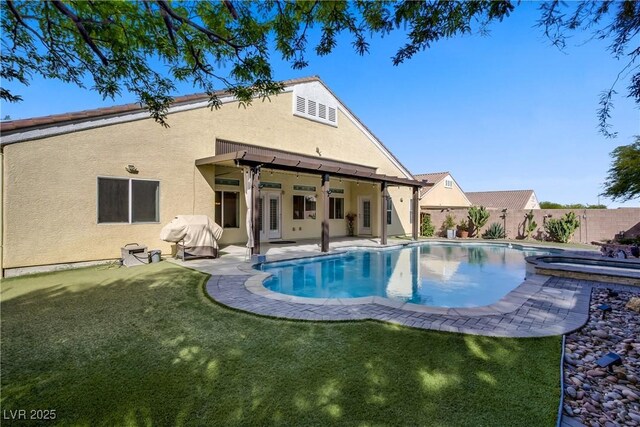 view of swimming pool with grilling area, a patio, a fenced backyard, a fenced in pool, and a yard