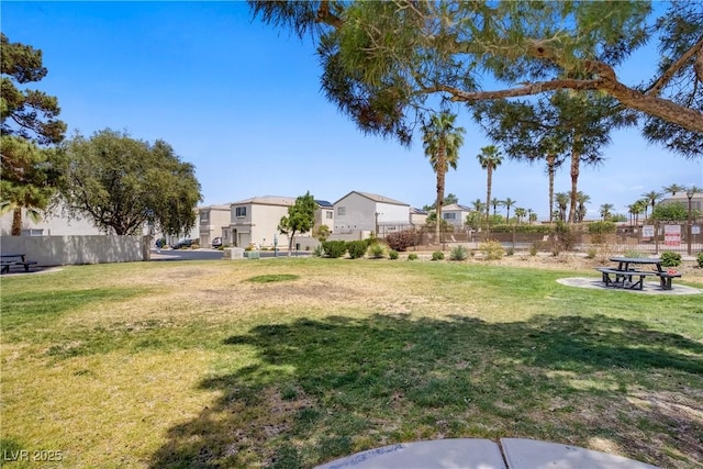 view of yard featuring fence and a residential view