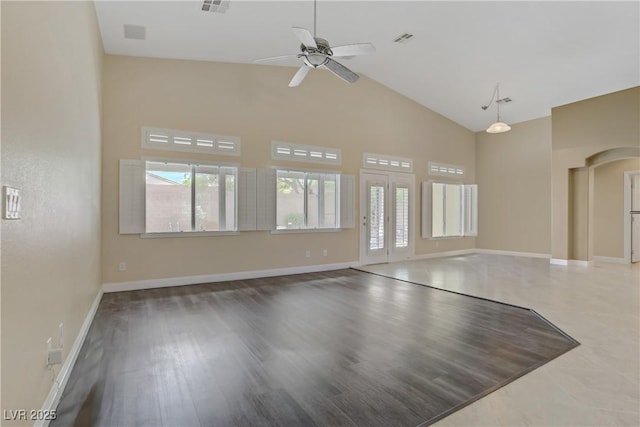 unfurnished living room with baseboards, a ceiling fan, and high vaulted ceiling