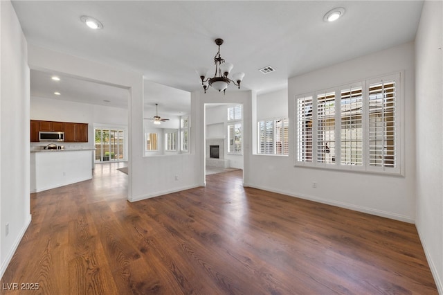 4217 Box Canyon Falls Ave, North Las Vegas, NV 89085 - unfurnished living room featuring baseboards, dark wood-style floors, and a wealth of natural light