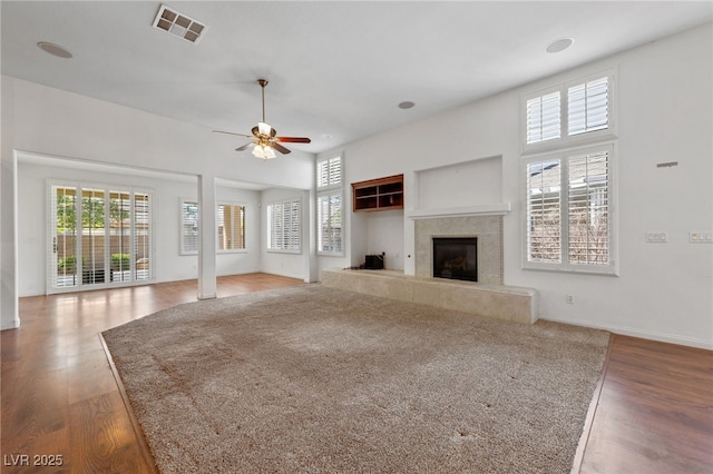4217 Box Canyon Falls Ave, North Las Vegas, NV 89085 - unfurnished living room with a ceiling fan, a premium fireplace, wood finished floors, and visible vents