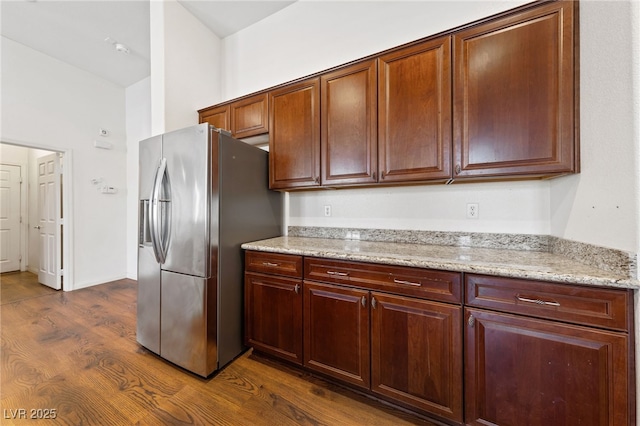 4217 Box Canyon Falls Ave, North Las Vegas, NV 89085 - kitchen featuring light stone countertops, dark wood finished floors, and stainless steel fridge