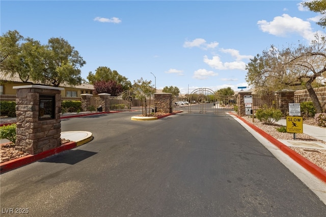 4217 Box Canyon Falls Ave, North Las Vegas, NV 89085 - view of road featuring a gate, a gated entry, and curbs