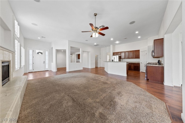 4217 Box Canyon Falls Ave, North Las Vegas, NV 89085 - unfurnished living room with recessed lighting, a ceiling fan, dark wood-style floors, and a fireplace
