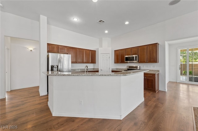4217 Box Canyon Falls Ave, North Las Vegas, NV 89085 - kitchen with visible vents, dark wood-style flooring, recessed lighting, a large island with sink, and appliances with stainless steel finishes