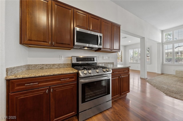 4217 Box Canyon Falls Ave, North Las Vegas, NV 89085 - kitchen with light stone countertops, appliances with stainless steel finishes, and dark wood-style floors