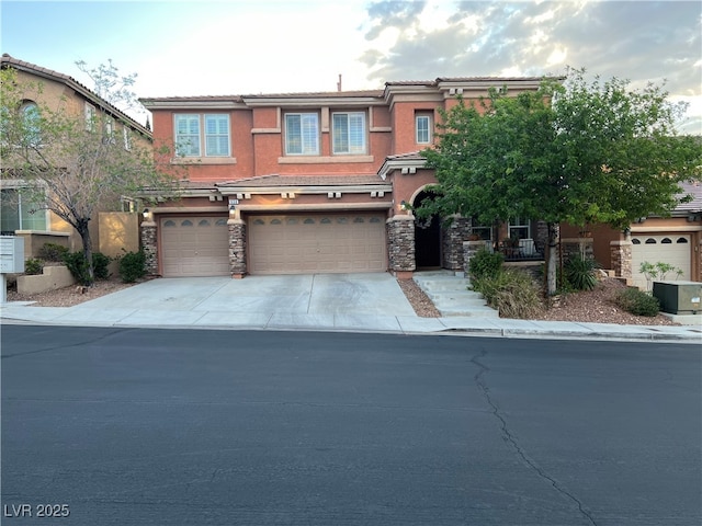 view of front facade with an attached garage, driveway, stone siding, and stucco siding