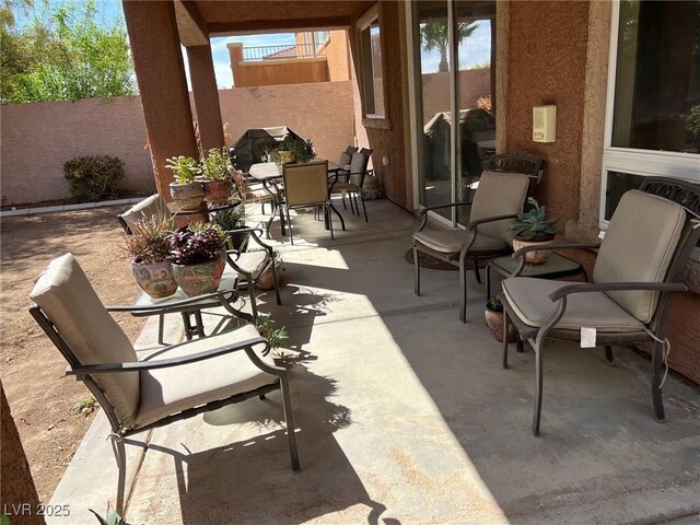 view of patio with fence and outdoor dining space