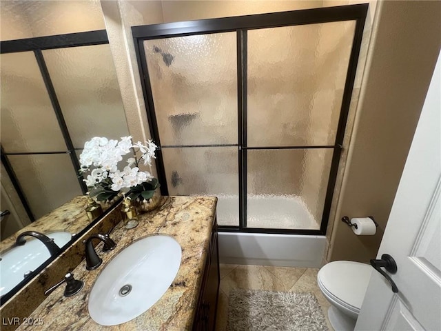 full bathroom featuring vanity, shower / bath combination with glass door, and toilet