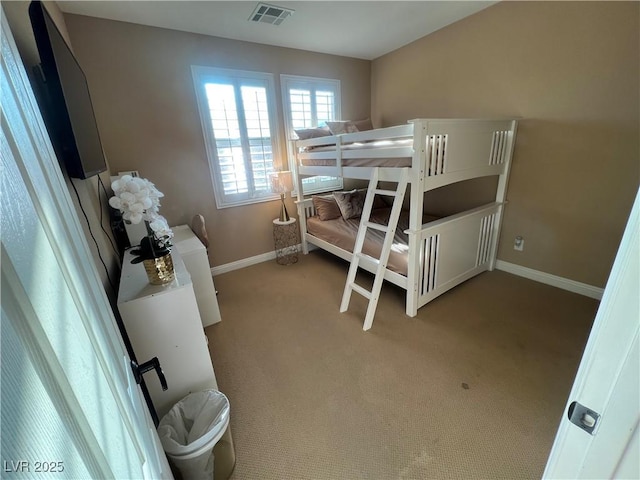 bedroom featuring light colored carpet, baseboards, and visible vents