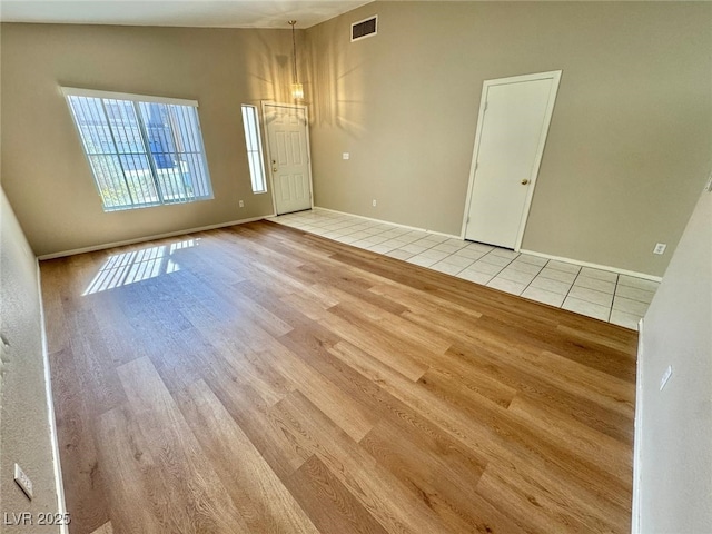 10025 Catseye Cove Ct, Las Vegas, NV 89183 - unfurnished room with a notable chandelier, baseboards, wood finished floors, vaulted ceiling, and visible vents