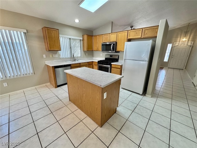 10025 Catseye Cove Ct, Las Vegas, NV 89183 - kitchen featuring lofted ceiling, light countertops, a sink, light tile patterned floors, and stainless steel appliances