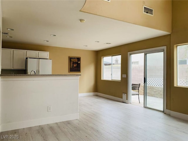 spare room with recessed lighting, baseboards, visible vents, and light wood-style flooring