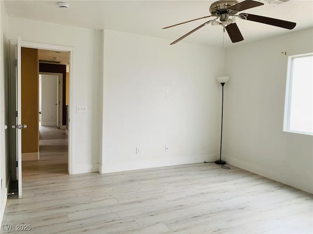 empty room with baseboards, light wood-style flooring, and ceiling fan