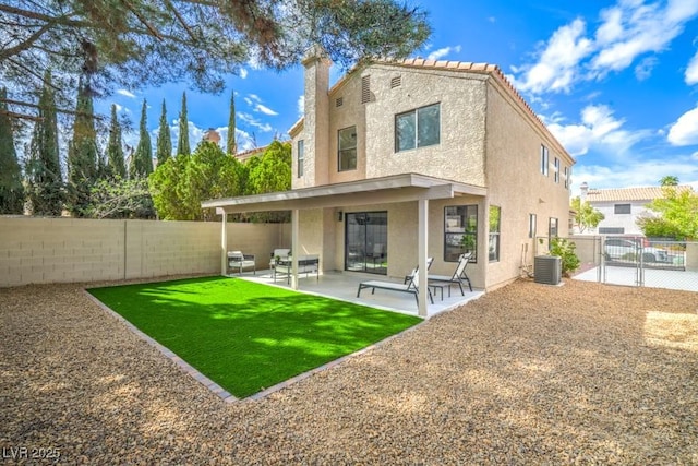 10009 Coral Sands Dr, Las Vegas, NV 89117 - rear view of property with stucco siding, a fenced backyard, central AC unit, a patio, and a yard