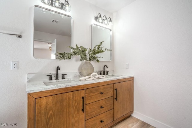 10009 Coral Sands Dr, Las Vegas, NV 89117 - full bathroom with visible vents, a sink, baseboards, and double vanity