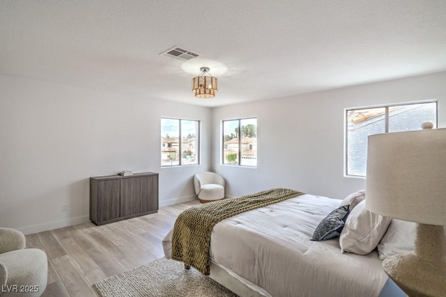 10009 Coral Sands Dr, Las Vegas, NV 89117 - bedroom with baseboards, visible vents, and light wood-style flooring