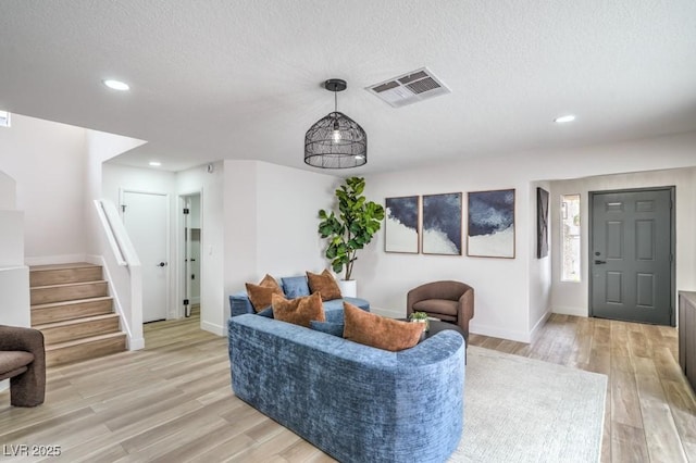 10009 Coral Sands Dr, Las Vegas, NV 89117 - living area featuring visible vents, light wood-style floors, baseboards, recessed lighting, and a textured ceiling