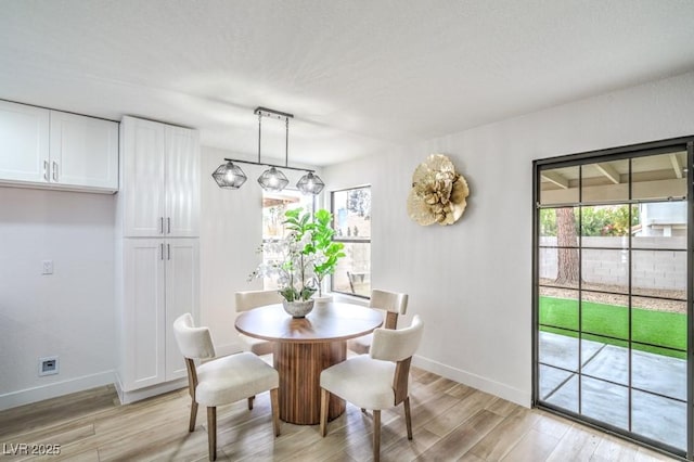 10009 Coral Sands Dr, Las Vegas, NV 89117 - dining room featuring baseboards and light wood-style flooring