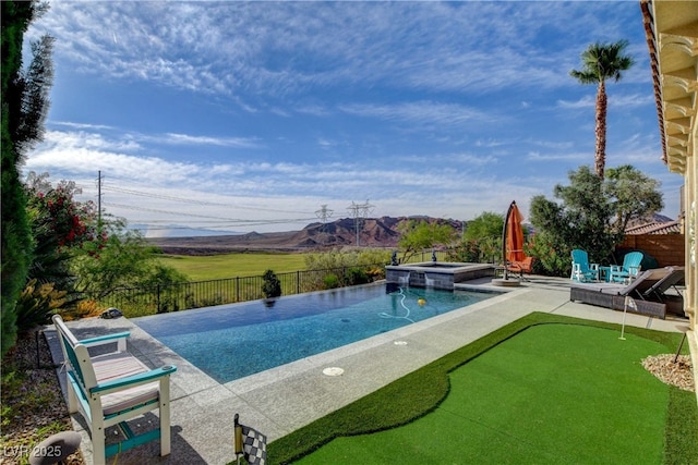 19 Contrada Fiore Dr, Henderson, NV 89011 - view of pool featuring a mountain view, a patio area, a pool with connected hot tub, and fence