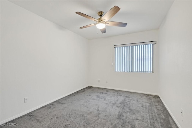 carpeted spare room with baseboards and ceiling fan