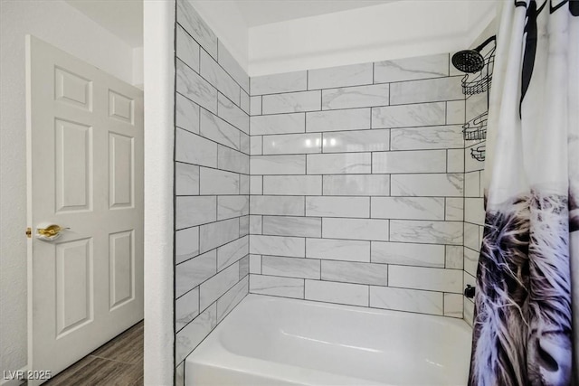 bathroom with shower / bath combo with shower curtain