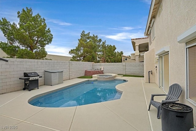 view of pool with grilling area, a pool with connected hot tub, a fenced backyard, and a patio area