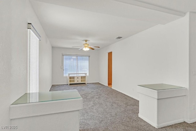 unfurnished room featuring baseboards, ceiling fan, and carpet flooring