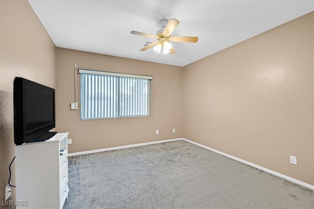 interior space with baseboards and a ceiling fan