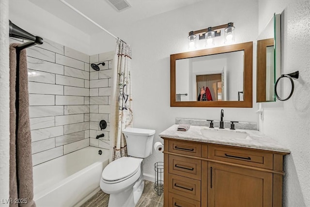 bathroom with visible vents, vanity, toilet, a textured wall, and shower / bath combo with shower curtain