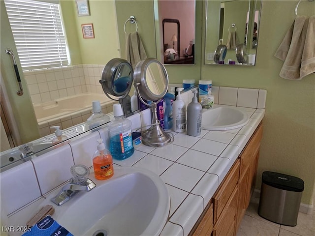 bathroom with double vanity, tile patterned floors, a sink, and a garden tub