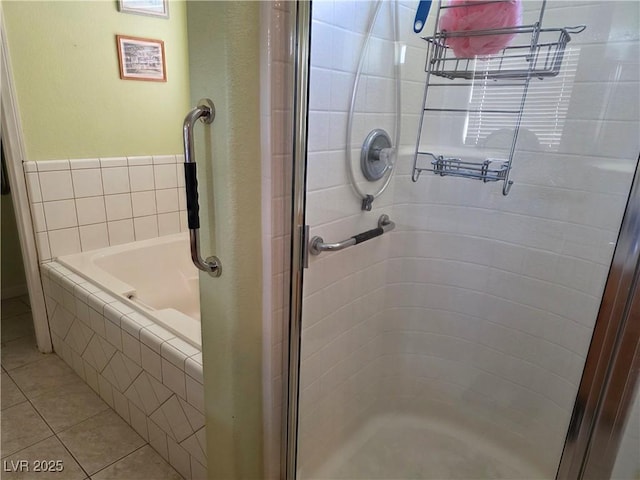 bathroom featuring tile patterned floors, a garden tub, and a stall shower