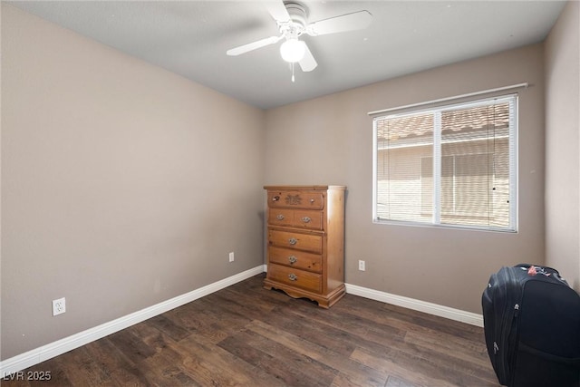 office with baseboards, a ceiling fan, and dark wood finished floors