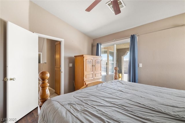 bedroom featuring access to outside, visible vents, a ceiling fan, wood finished floors, and vaulted ceiling