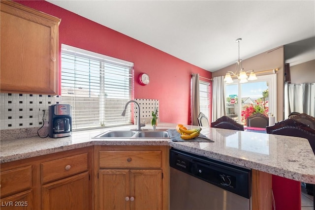 kitchen with a sink, a chandelier, a peninsula, backsplash, and stainless steel dishwasher