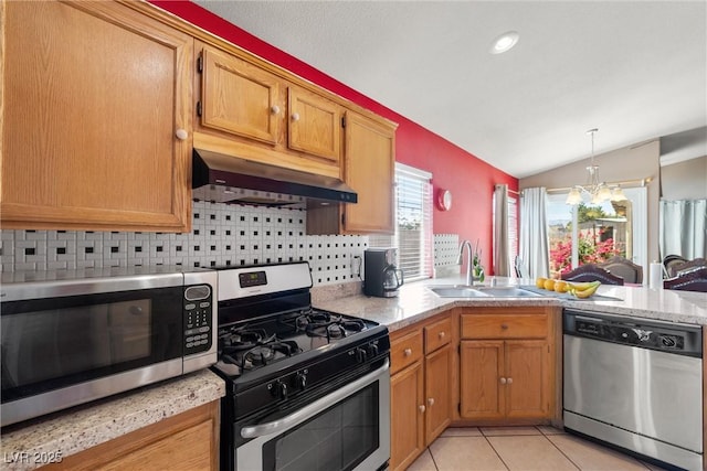 kitchen featuring under cabinet range hood, stainless steel appliances, vaulted ceiling, and tasteful backsplash