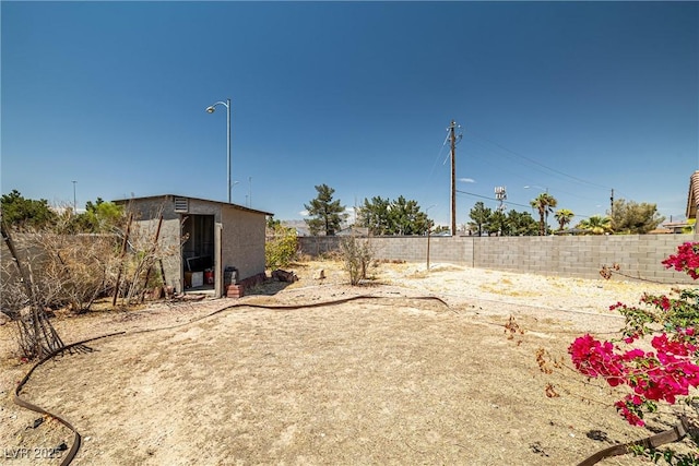 view of yard with an outbuilding and a fenced backyard