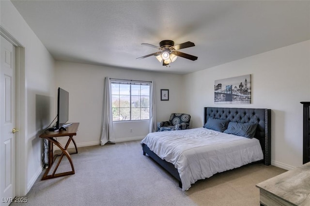 bedroom featuring baseboards, ceiling fan, and light carpet