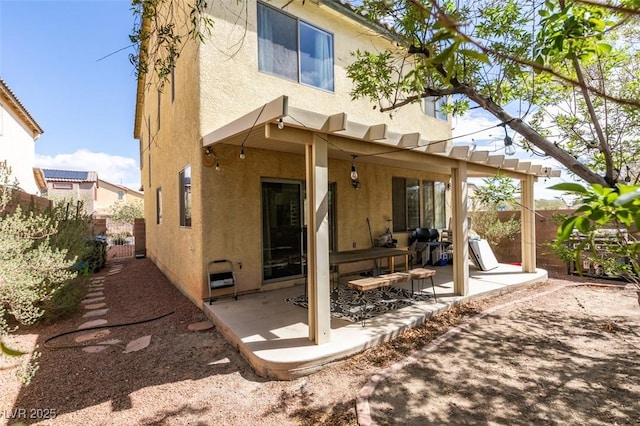 back of house featuring a fenced backyard, a patio area, and stucco siding