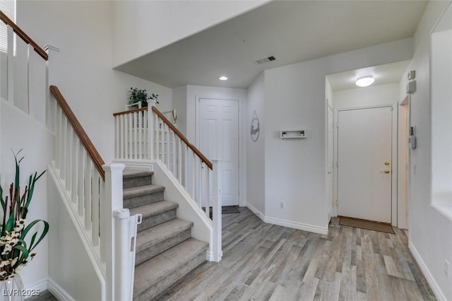 entrance foyer with visible vents, recessed lighting, light wood-style flooring, and stairway
