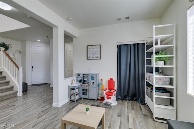 rec room featuring visible vents, baseboards, and wood finished floors