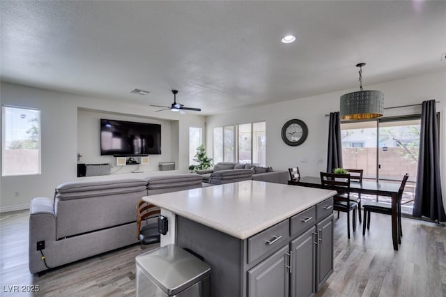 kitchen featuring a wealth of natural light, gray cabinets, and light wood-style floors